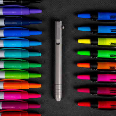 Big Idea Design Bolt Action Marker in silver surrounded by colorful permanent markers
