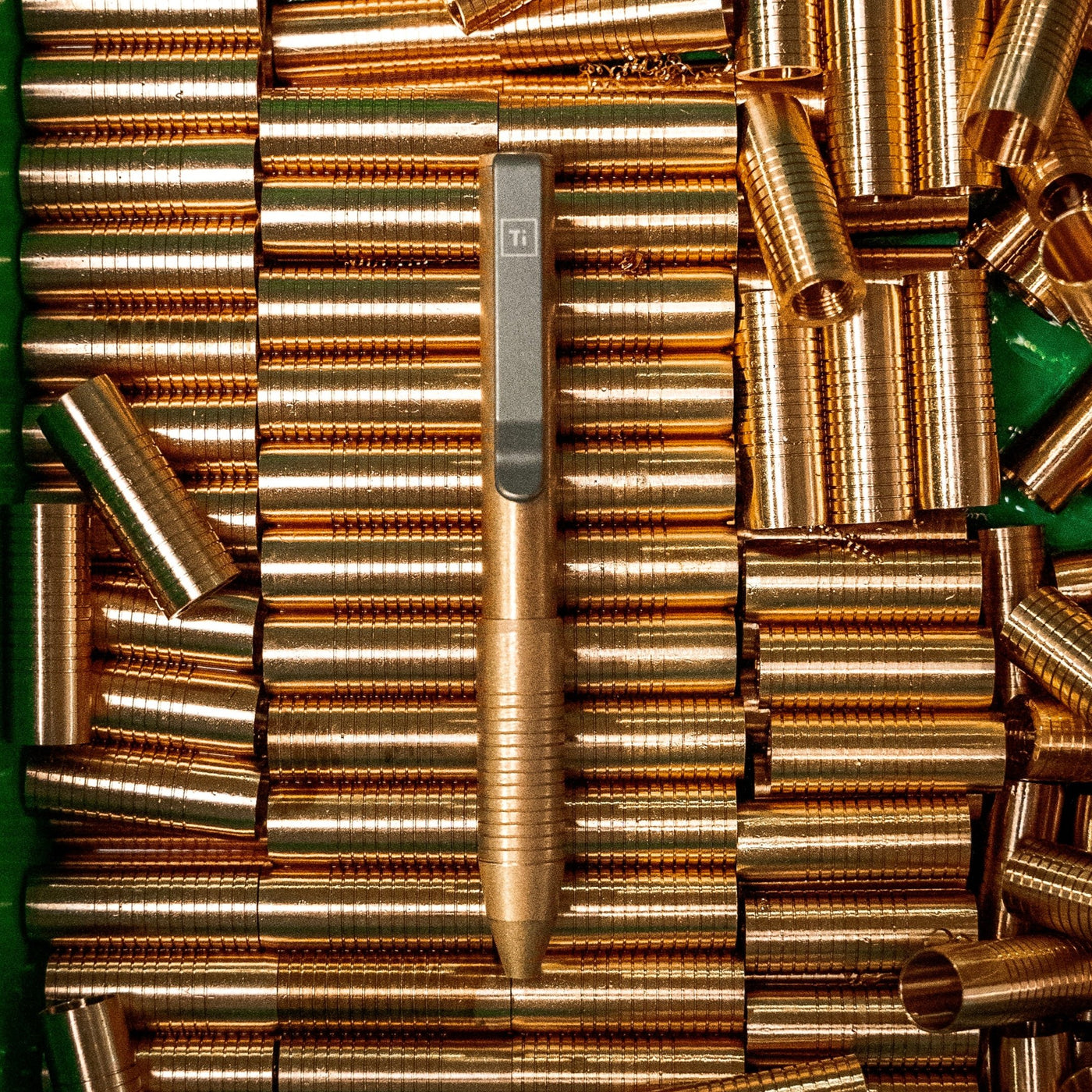 Bronze EDC pen made in USA by BIGiDESIGN-USA displayed on bronze pen barrels