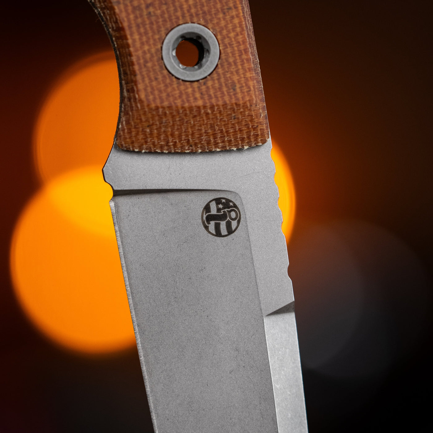BIGiDESIGN-USA fixed blad knife with textured brown handle and stainless steel blade close-up