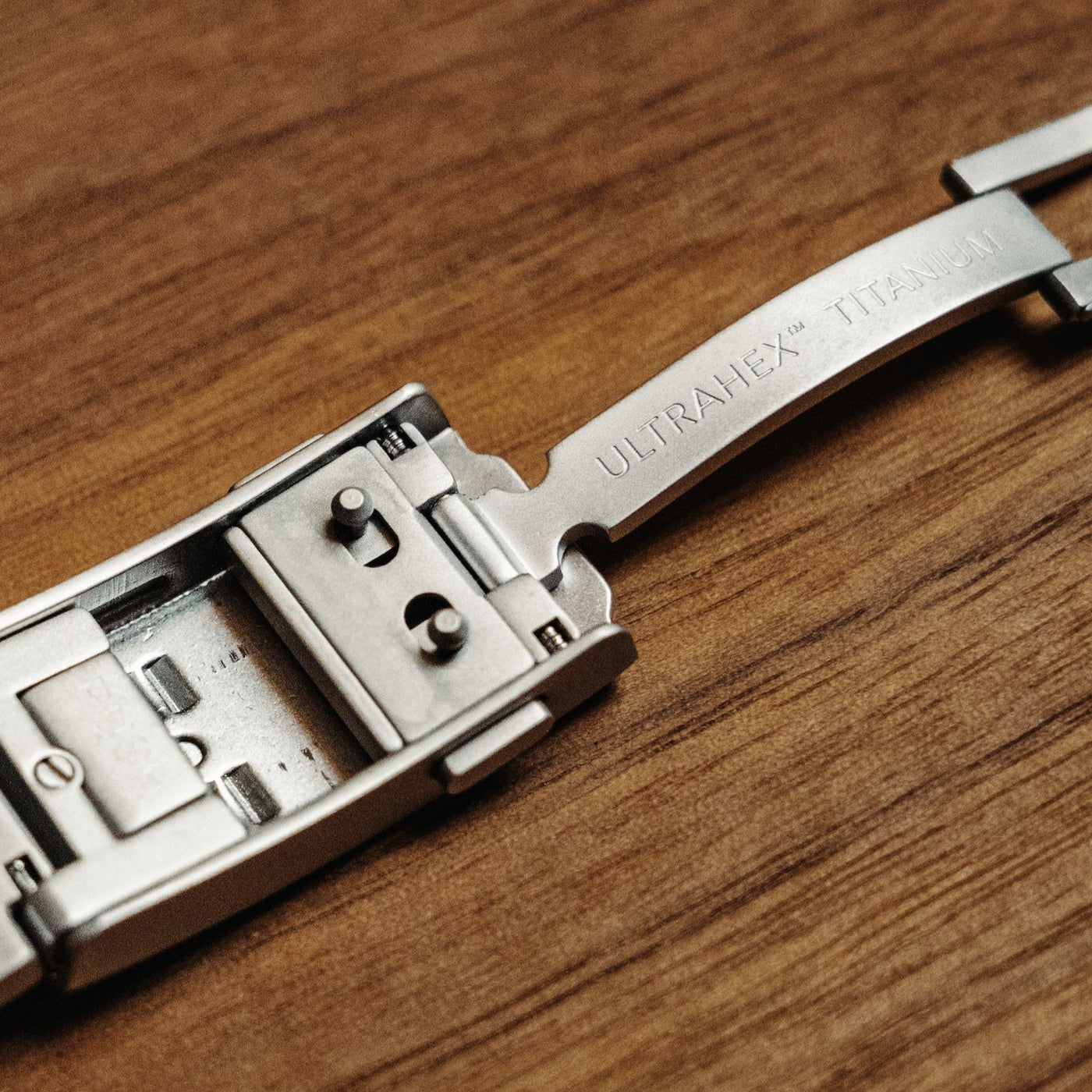 Big Idea Design titanium GMT watch close up of titanium bracelet clasp with ULTRAHEX engraving