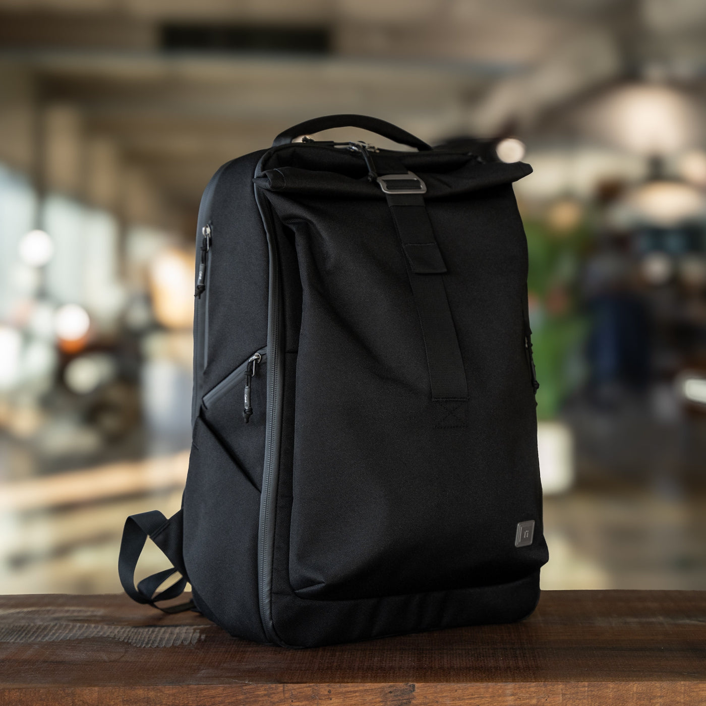Big Idea Design LLC black everyday carry backpack with roll-top and side zipper pockets