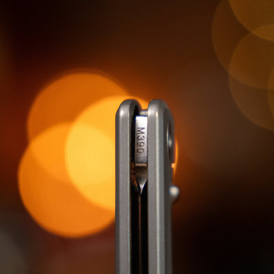 Close-up view of Big Idea Design LLC titanium pocket knife showing blade detail with M390 steel