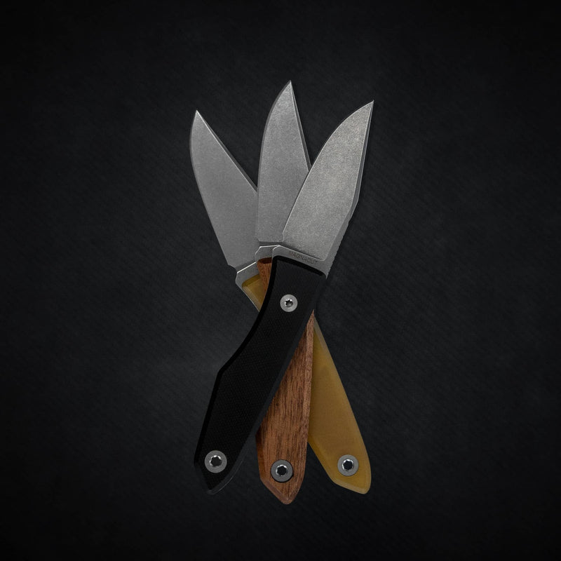 Three USA lookout fixed blade knives with black, wood, and tan handles displayed on black background