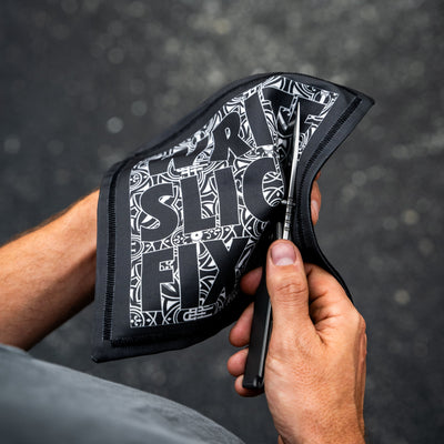 Person holding Write Slice Fix Hank accessory with black and white design for cleaning knives
