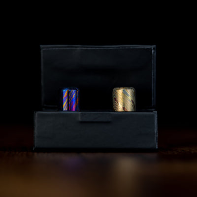 Big Idea Design LLC Damascus lanyard bead set in a black display box with intricate metal patterns