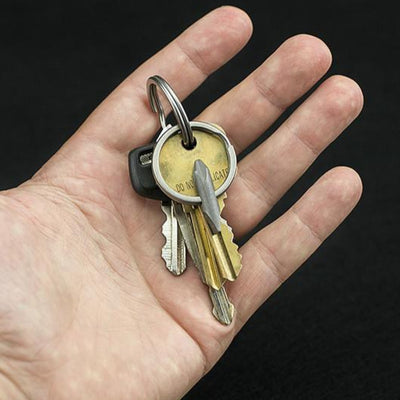 Hand holding keys on a ring with a compact EDC screwdriver tool attached for everyday use