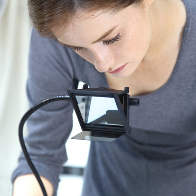 Woman using NeoLucida XL camera lucida drawing aid with adjustable arm for tracing artwork