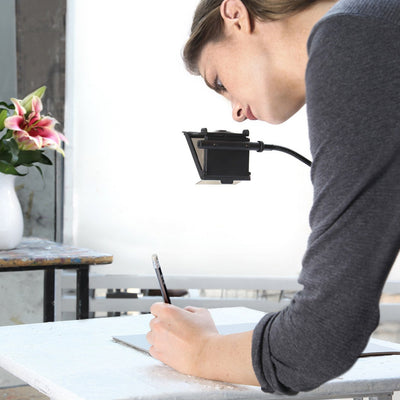 Artist using NeoLucida XL camera lucida drawing aid by BIG IDEA DESIGN LLC to sketch on paper