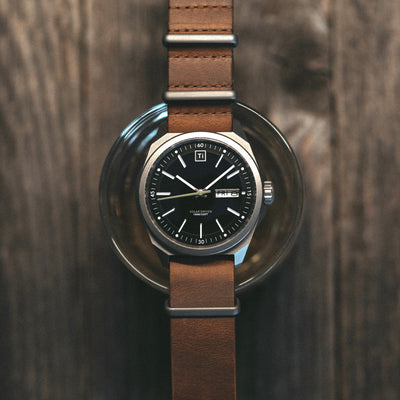 Solar titanium field watch with black dial and brown leather strap