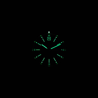 Big Idea Design LLC solar titanium field watch glowing green luminous dial in the dark