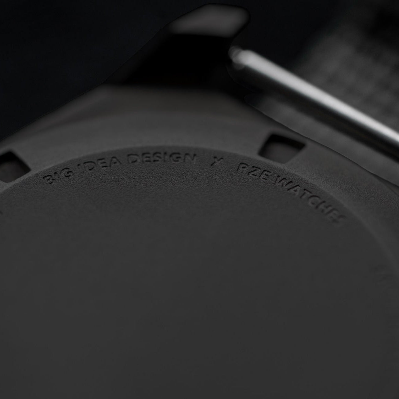 Close-up of Big Idea Design LLC solar powered titanium watch back case with engraved branding