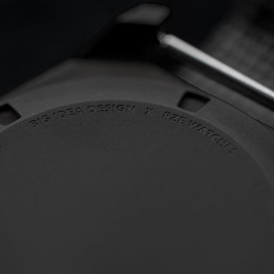 Close-up of Big Idea Design LLC solar powered titanium watch back case with engraved branding