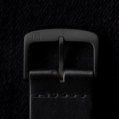 Close-up of black buckle detail on a solar powered titanium watch leather strap