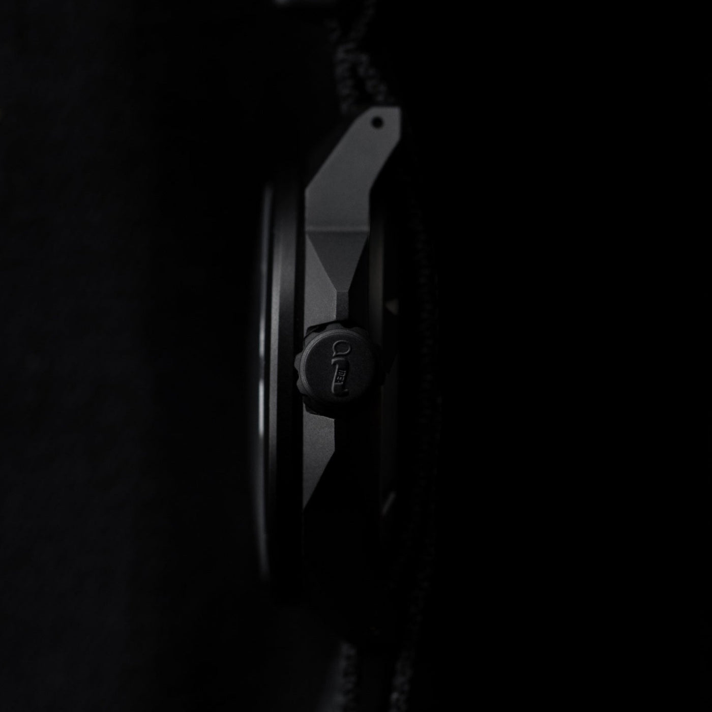 Side profile view of Big Idea Design LLC solar powered titanium watch with matte black finish