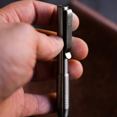BIG IDEA DESIGN LLC titanium pocket pen held in hand showing clip and compact metal body pens