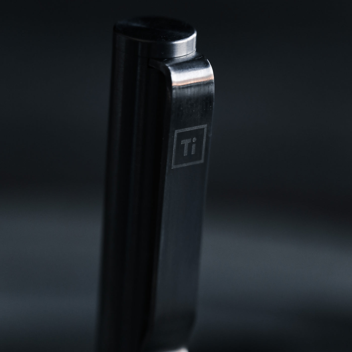 Close up of black titanium pen clip engraved Ti by BIG IDEA DESIGN LLC showing sleek metal finish for premium Pens