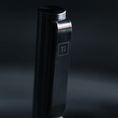 Close up of black titanium pen clip engraved Ti by BIG IDEA DESIGN LLC showing sleek metal finish for premium Pens