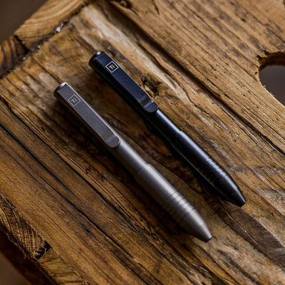 BIG IDEA DESIGN LLC Pens two compact metal pens in black and gunmetal on rustic wood for everyday carry
