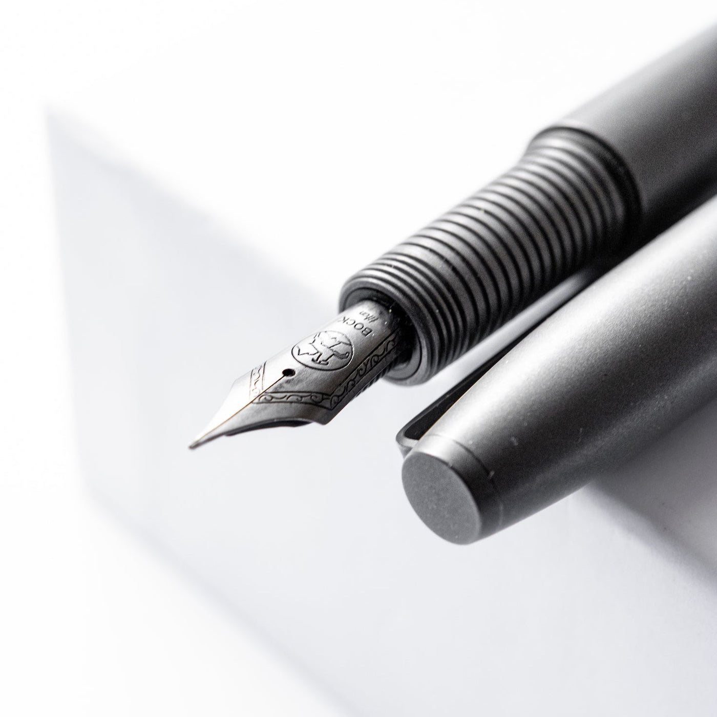 Big Idea Design LLC Titanium Fountain Pen with matte black finish and detailed nib close-up