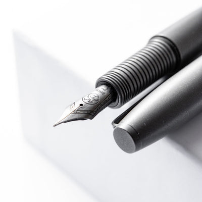 Big Idea Design LLC Titanium Fountain Pen with matte black finish and detailed nib close-up