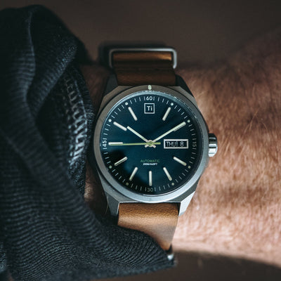 Big Idea Design LLC titanium automatic field watch with brown leather strap on wrist