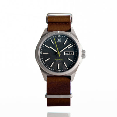 Big Idea Design LLC titanium automatic field watch with black dial and brown leather strap