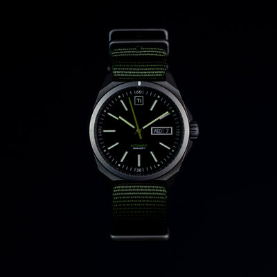 Big Idea Design LLC titanium automatic field watch with black dial and green nylon strap