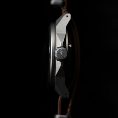 Side view of Big Idea Design LLC titanium automatic field watch showing crown and case details