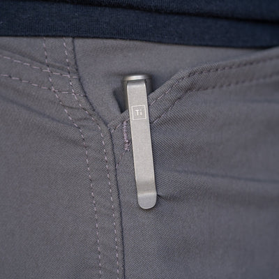 Titanium bolt action pen clipped to the pocket of gray pants by Big Idea Design LLC