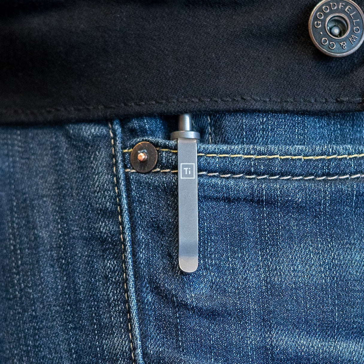 Big Idea Design LLC titanium EDC pen clipped to blue jeans pocket with metal button detail
