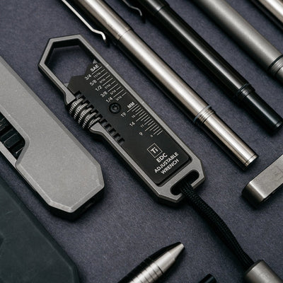 BIG IDEA DESIGN LLC titanium EDC wrench with adjustable sizes and measurement markings surrounded by metal tools