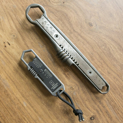 BIG IDEA DESIGN LLC titanium EDC wrench set with two metal multitools on wooden surface