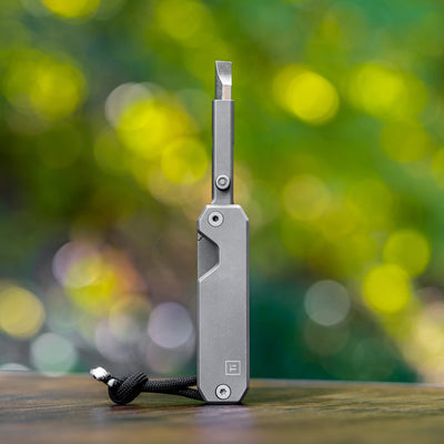 Big Idea Design LLC titanium everyday screwdriver with compact, sleek design on wooden surface