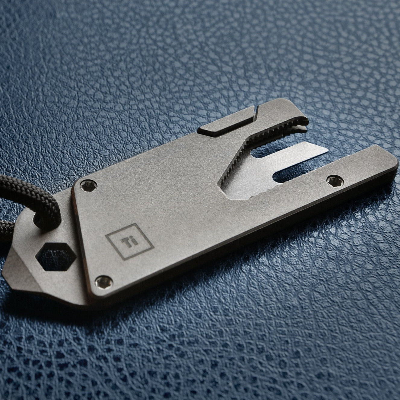 BIG IDEA DESIGN LLC Titanium Pocket Tool EDC with multi-function design and compact form on textured surface