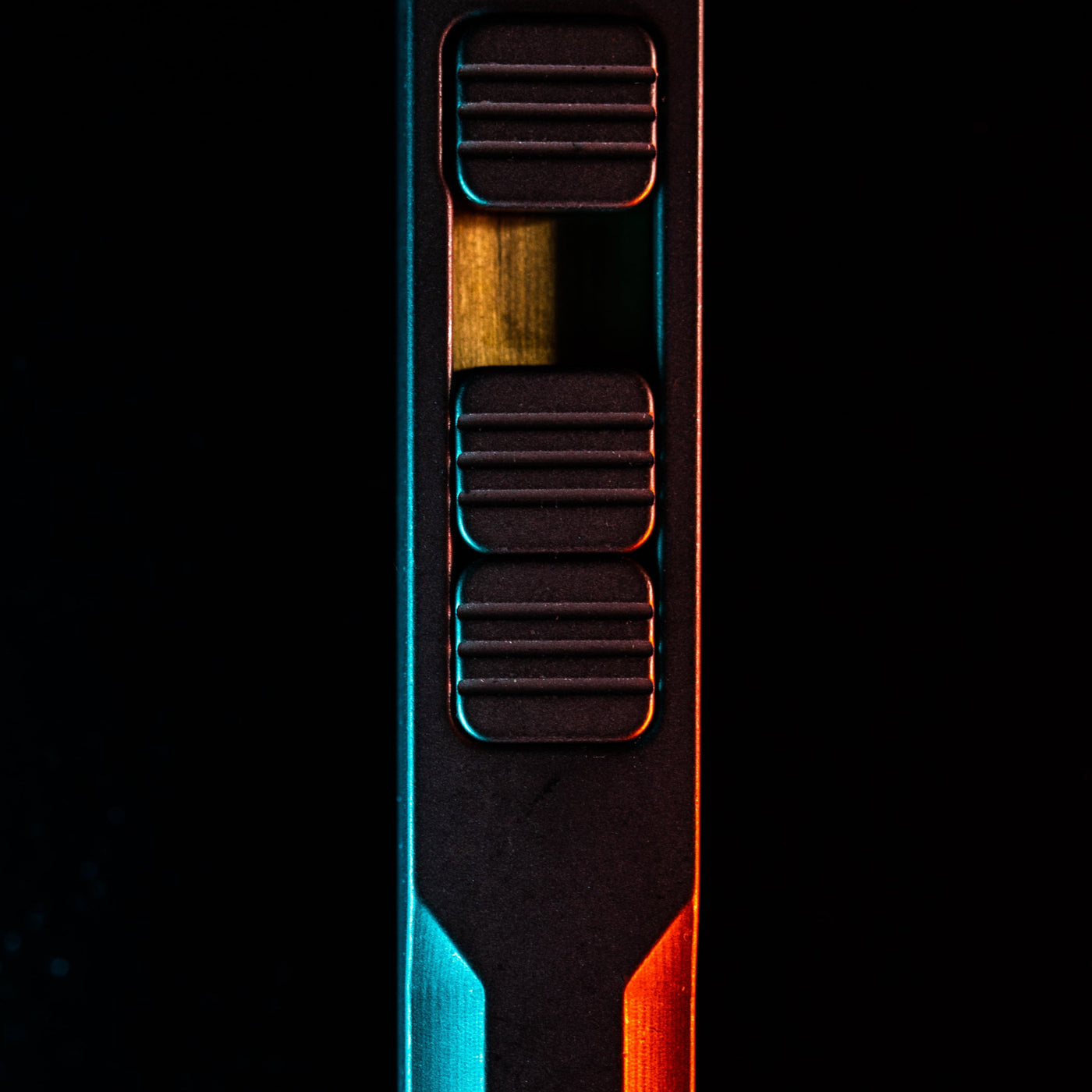 Close-up of titanium pry bar tool by Big Idea Design LLC with textured grip and sleek black finish