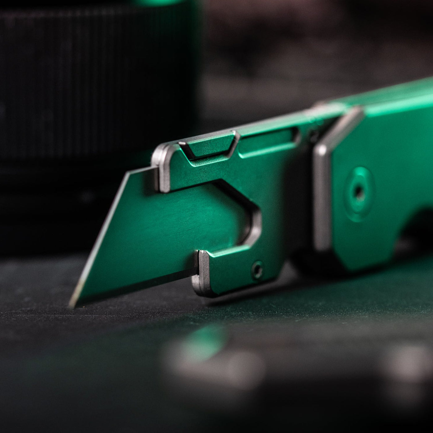 Big Idea Design LLC titanium utility knife with sleek green metal body and sharp blade close-up
