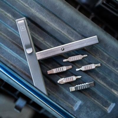 Big Idea Design LLC titanium screwdriver set with multiple interchangeable bits on a textured surface